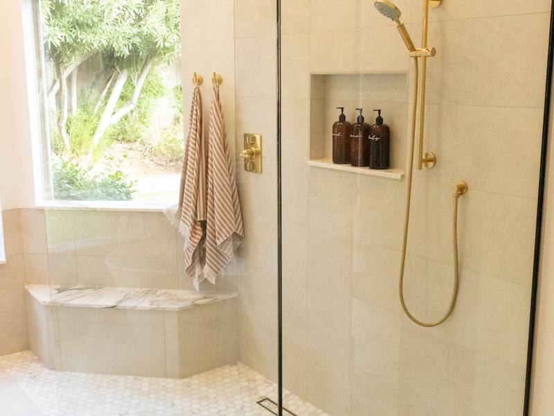Tiled walk-in shower with bench